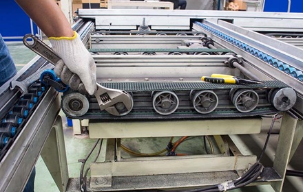 Home repair and maintenance with large wrench on conveyor belt